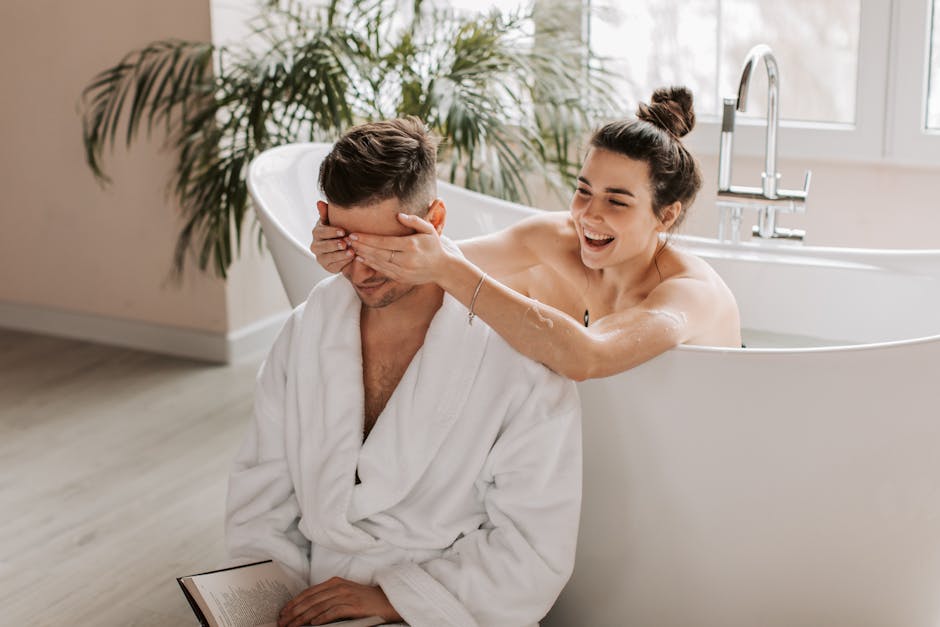 A playful couple enjoys a relaxing moment in the bathroom, creating memories.