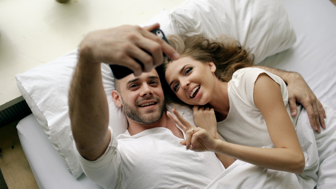 Couple taking a selfie in bed