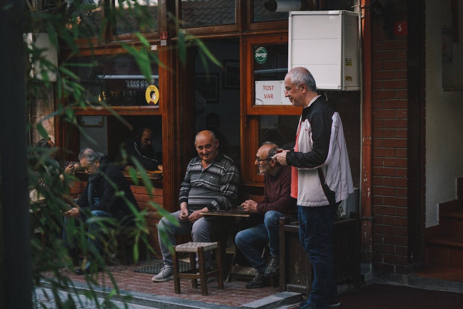 Three elderly males enjoying a conversation outside a cozy cafe.