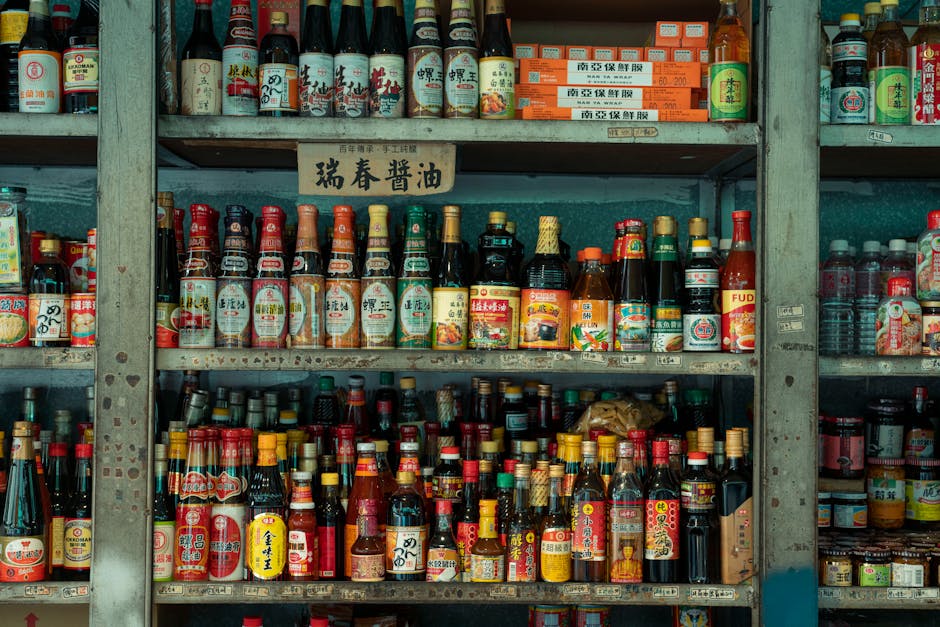 Colorful display of Asian sauces and condiments on market shelves in New Taipei City, Taiwan.