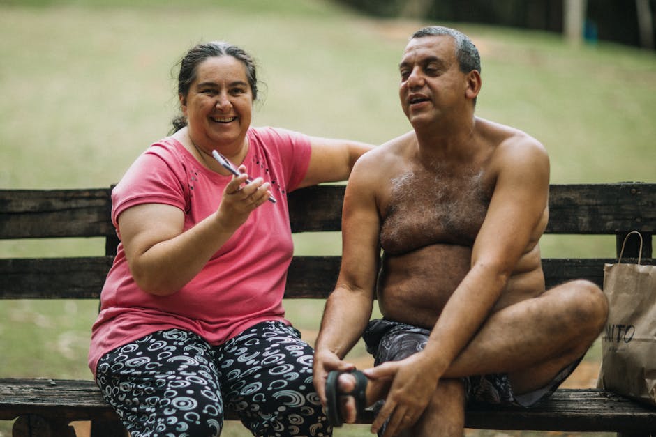 Smiling couple enjoying a relaxing moment on a park bench, feeling happy and content.