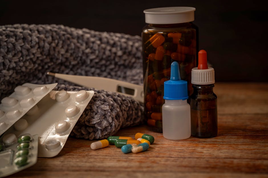 Collection of flu remedies including pills, thermometer, and scarf for winter cold relief.