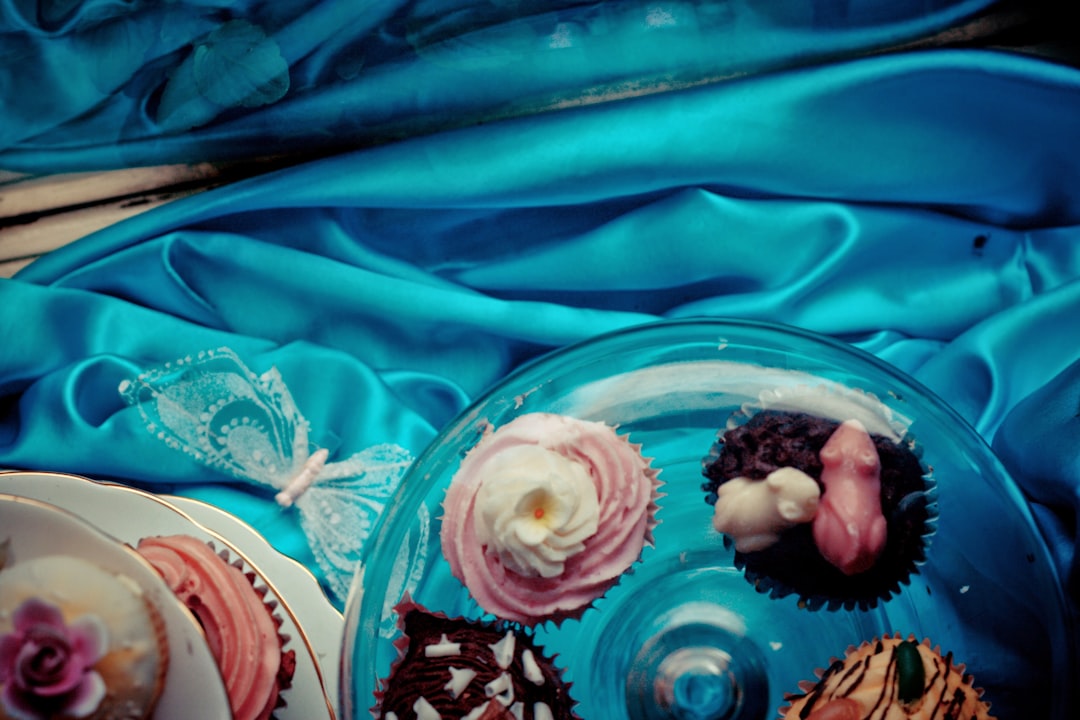 a plate of cupcakes on a blue cloth