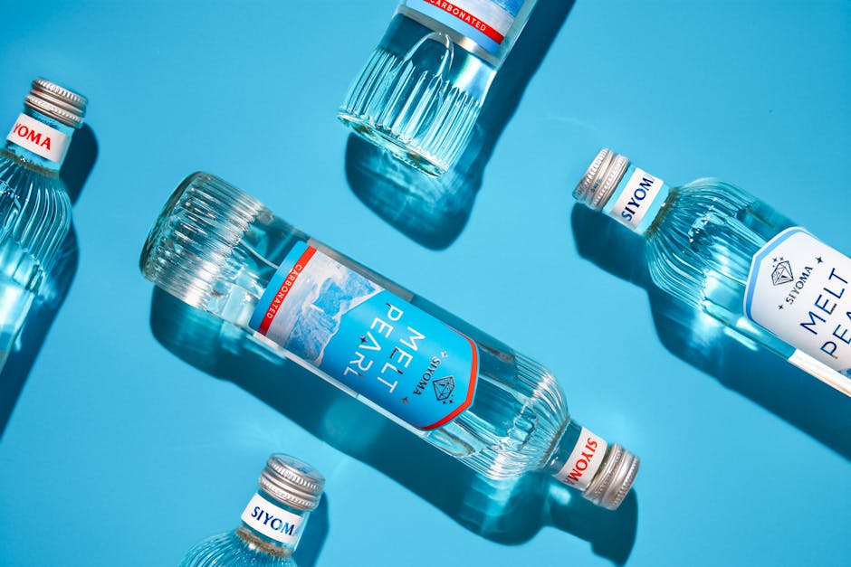 Sparkling water bottles laid on a vibrant blue surface showcasing freshness and clarity.